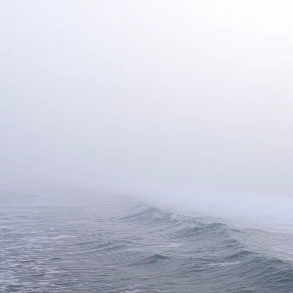 Thick fog rolling over the shoreline of Lake Michigan.