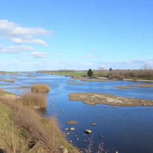 Scenic view of Huron River showing pollution warnings