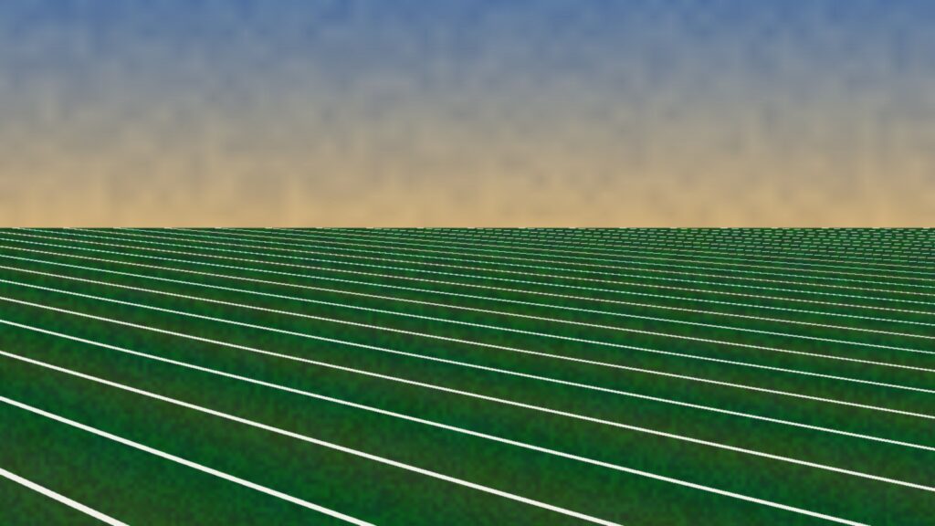Empty football field with white yard lines under a warm late-day sky
