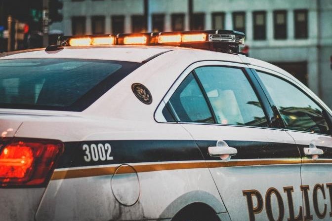 Police car lights on a city street at night
