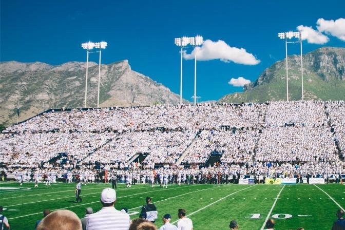 Football stadium with a crowd and mountains behind