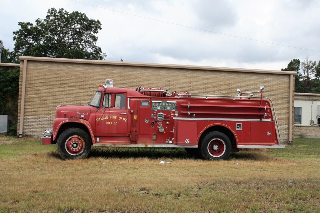 Red fire engine parked outside a station